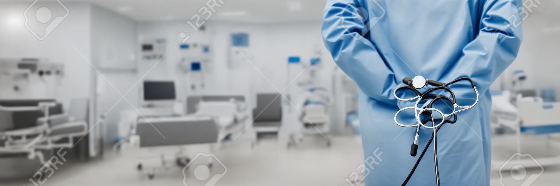 rear view of a male doctor with stethoscope in hospital ward.