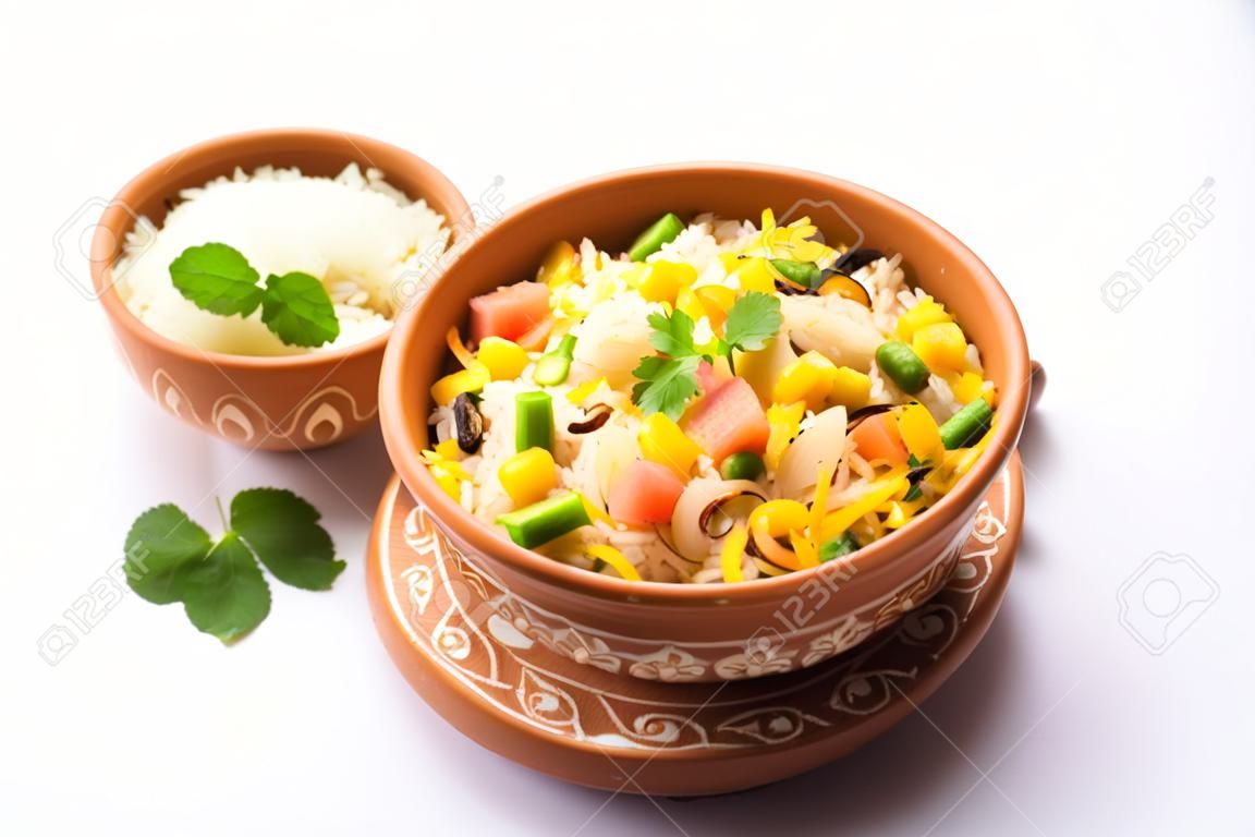 Indian Vegetable Pulav or Biryani made using Basmati Rice, served in a ceramic bowl. selective focus