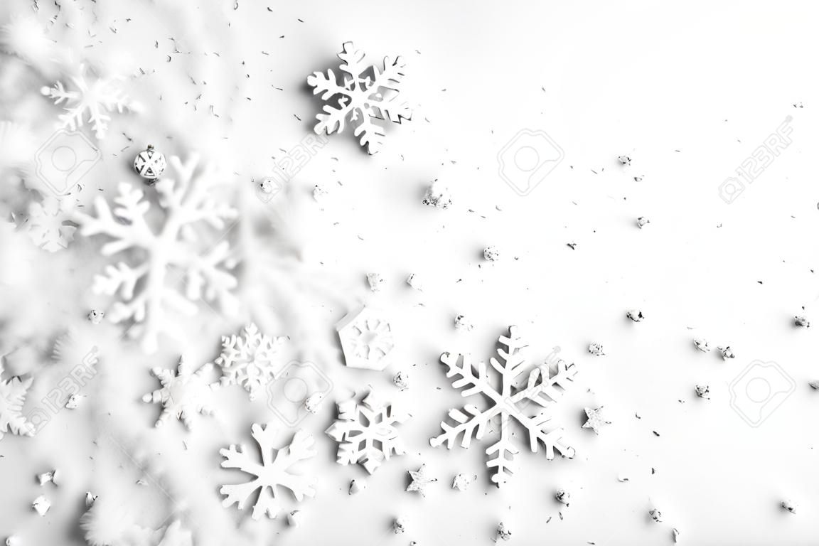 Christmas background with copy space made of snowflakes and snow on pastel gray background. Winter concept. Flat lay, top view, copy space