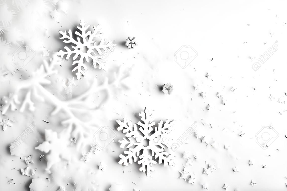 Christmas background with copy space made of snowflakes and snow on pastel gray background. Winter concept. Flat lay, top view, copy space