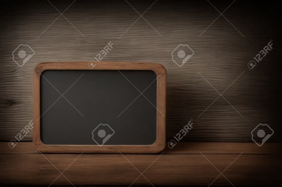 blank small blackboard on old wood background