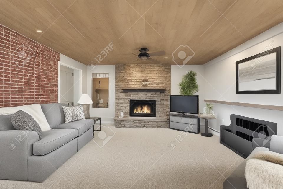 Cozy American living room with gray sofa, carpet floor and brick fireplace.