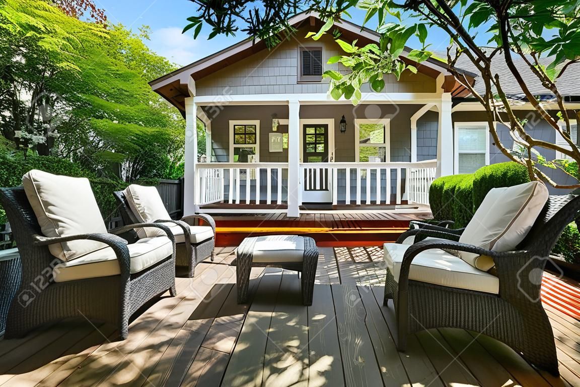 Cozy wooden floor patio area at backyard of craftsman American house. Northwest, USA