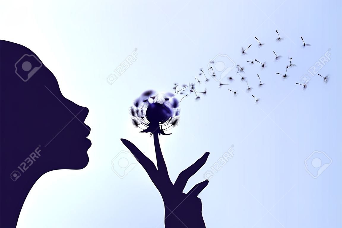 Silhouette of a woman blowing the dandelion