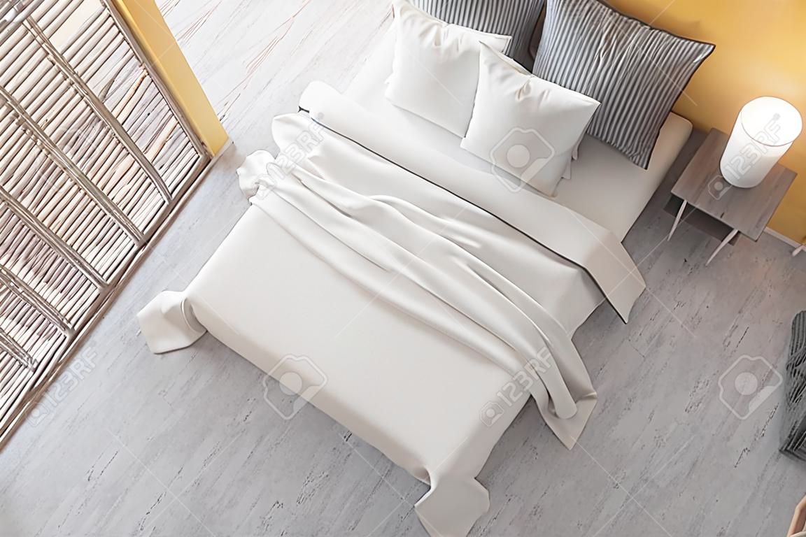 Vista superior do quarto elegante com paredes amarelas, piso de concreto, cama confortável com cobertor branco e guarda-roupa de madeira.
