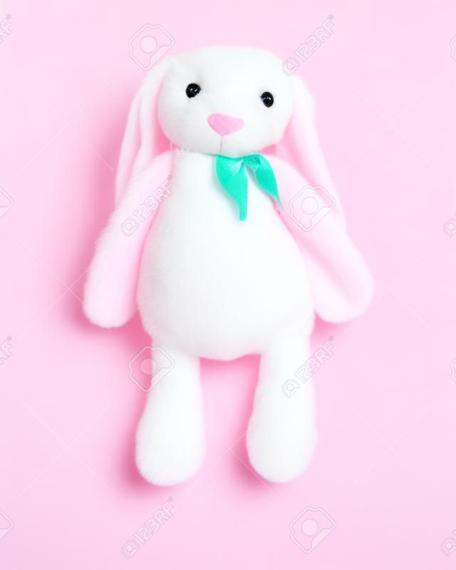 Pink rabbit doll with big ears isolated on white background. Cute stuffed animal and fluffy fur for kids.