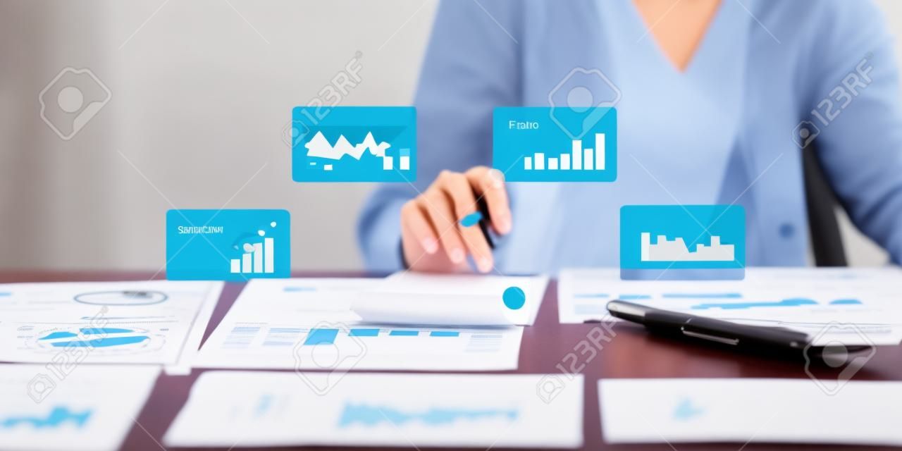 Business woman hand holding pen and pointing at financial paperwork with social network diagram.