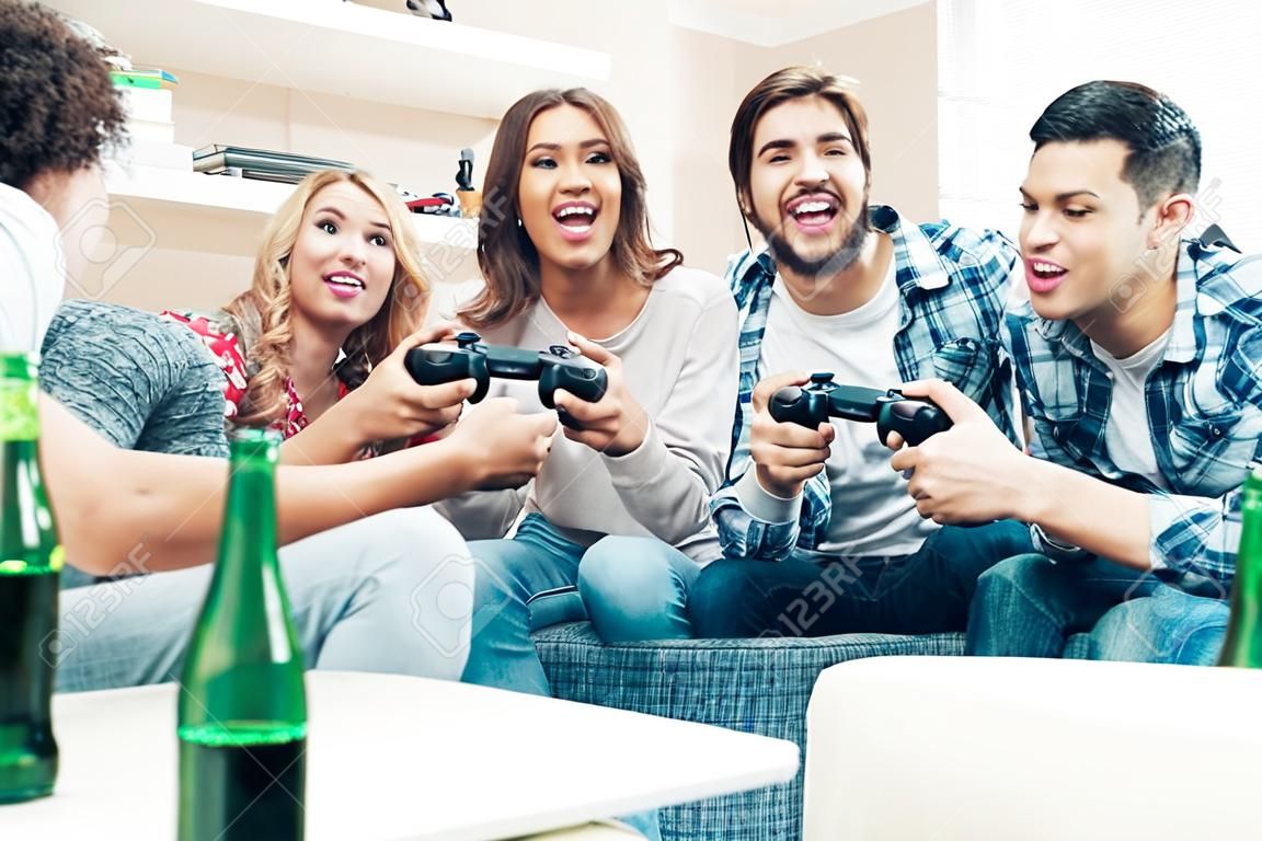 Group of friends having fun and  play video games together.