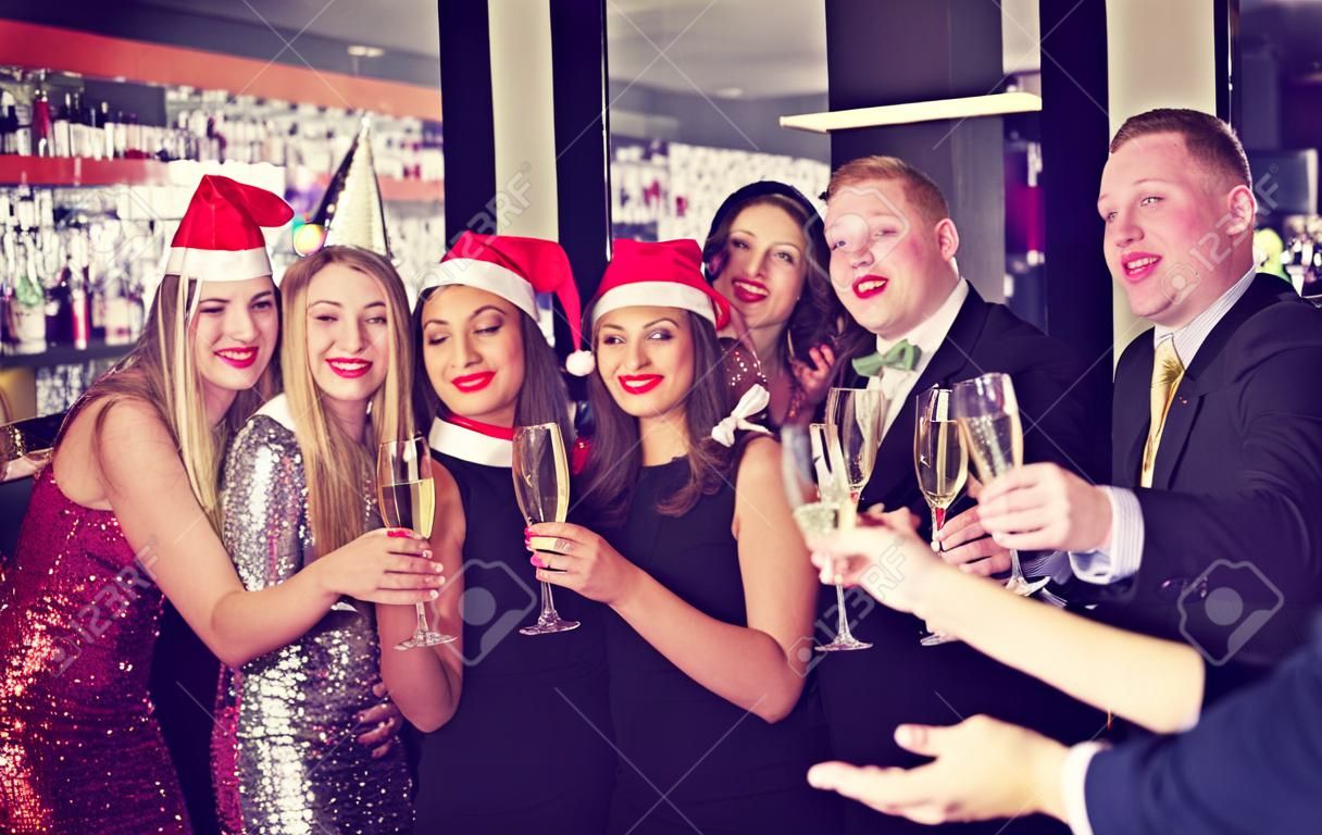 Felice amichevole collettivo godendo festa aziendale di Capodanno nel bar