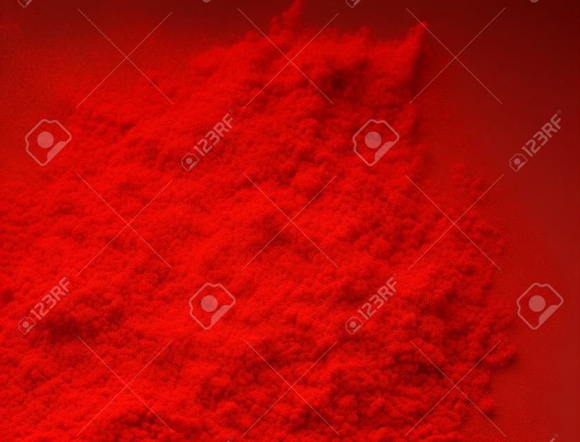 Explosion of red powder, isolated on white background
