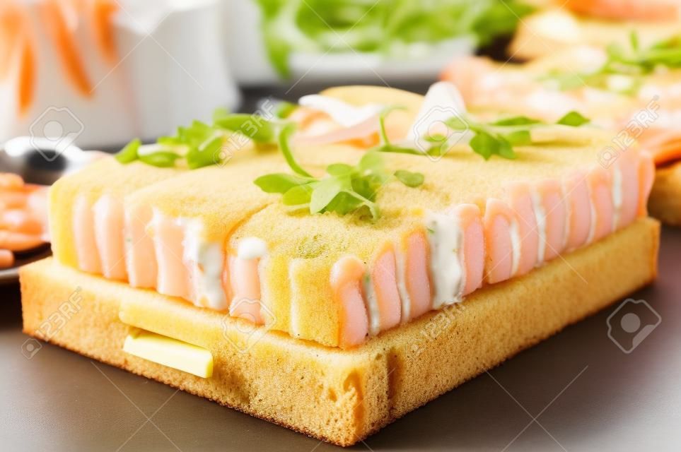 Smörgåstårta, Swedish sandwich like cake or sandwich torte is a dish with seafood ingredients like salmon, shrimps and prawns.