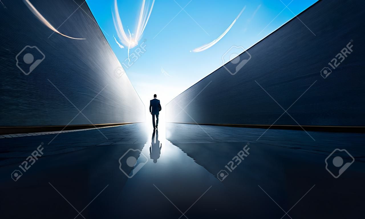 Freedom concept with businessman walking from alley to open space .
