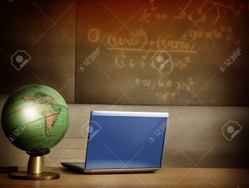 laptop and globe on table of teacher ( Filtered image processed vintage effect. )