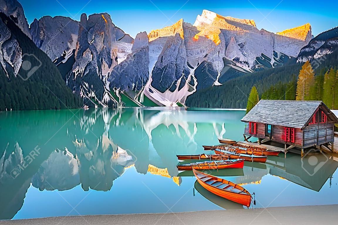 Breathtaking alpine touristic, recreation, hiking and photography place. Cute wooden boathouse and wooden boats in row on the lake, Lake Braies, Dolomites, Italy, Europe