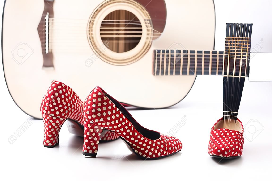 shoes of a flamenco dancer with a guitar in the background