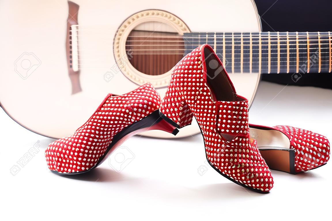 shoes of a flamenco dancer with a guitar in the background