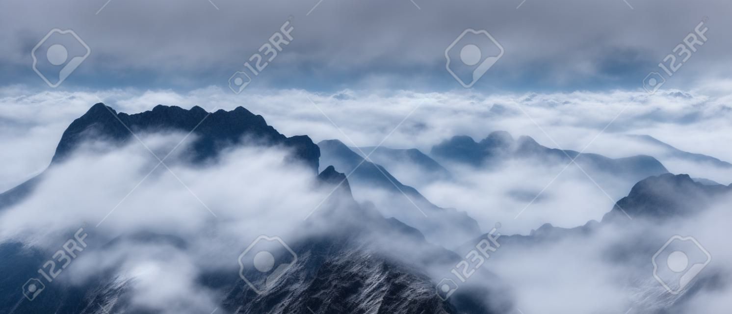 View on the mountains covered in fog from Mangart Pass that connects Italian and Slovenian side, Mangart pass
