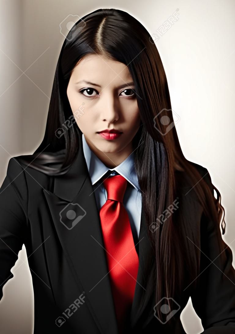 young woman dressed up in a man suit and tie looking at camera