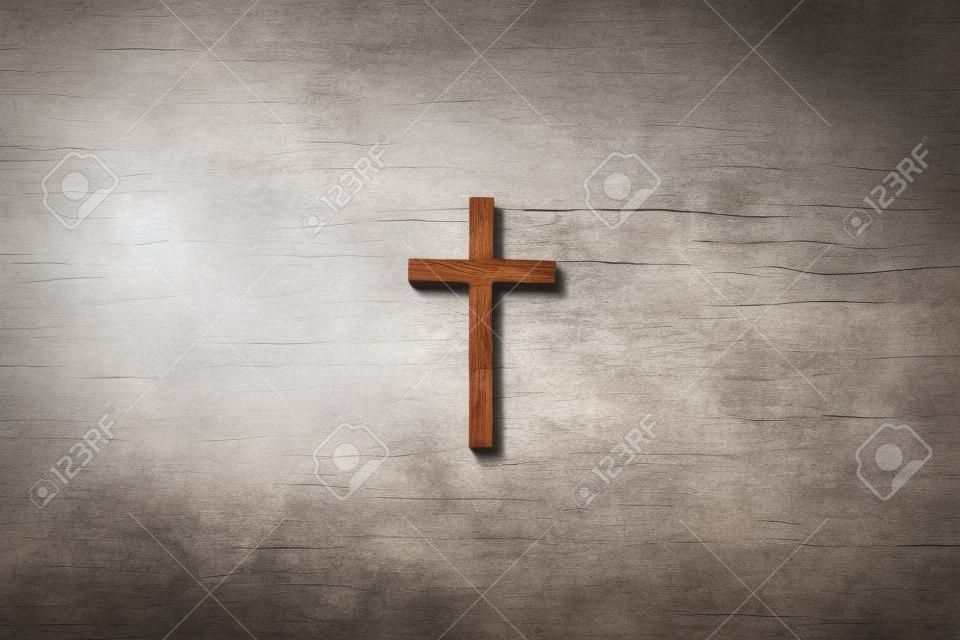 Wooden cross on marble background. Reminder of Jesus sacrifice and Christ resurrection. Easter passover. Palm sunday, Good friday concept. Christianity symbol and faith.