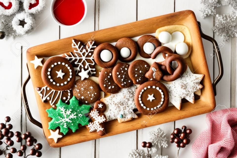 Plateau de biscuits de Noël et cuisson, scène de table vue de dessus sur bois blanc