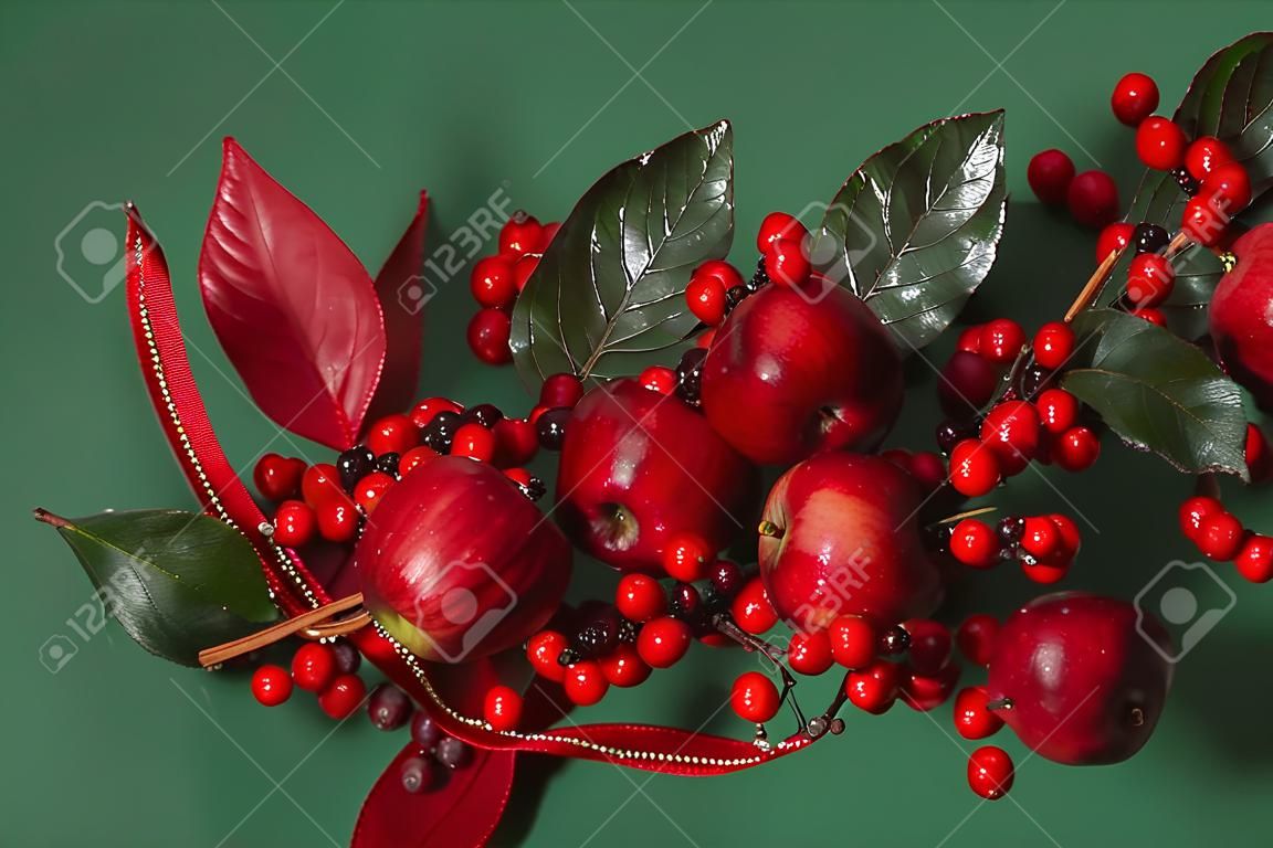 Christmas or Thanksgiving decoration with apples and cranberries against a festive holiday background