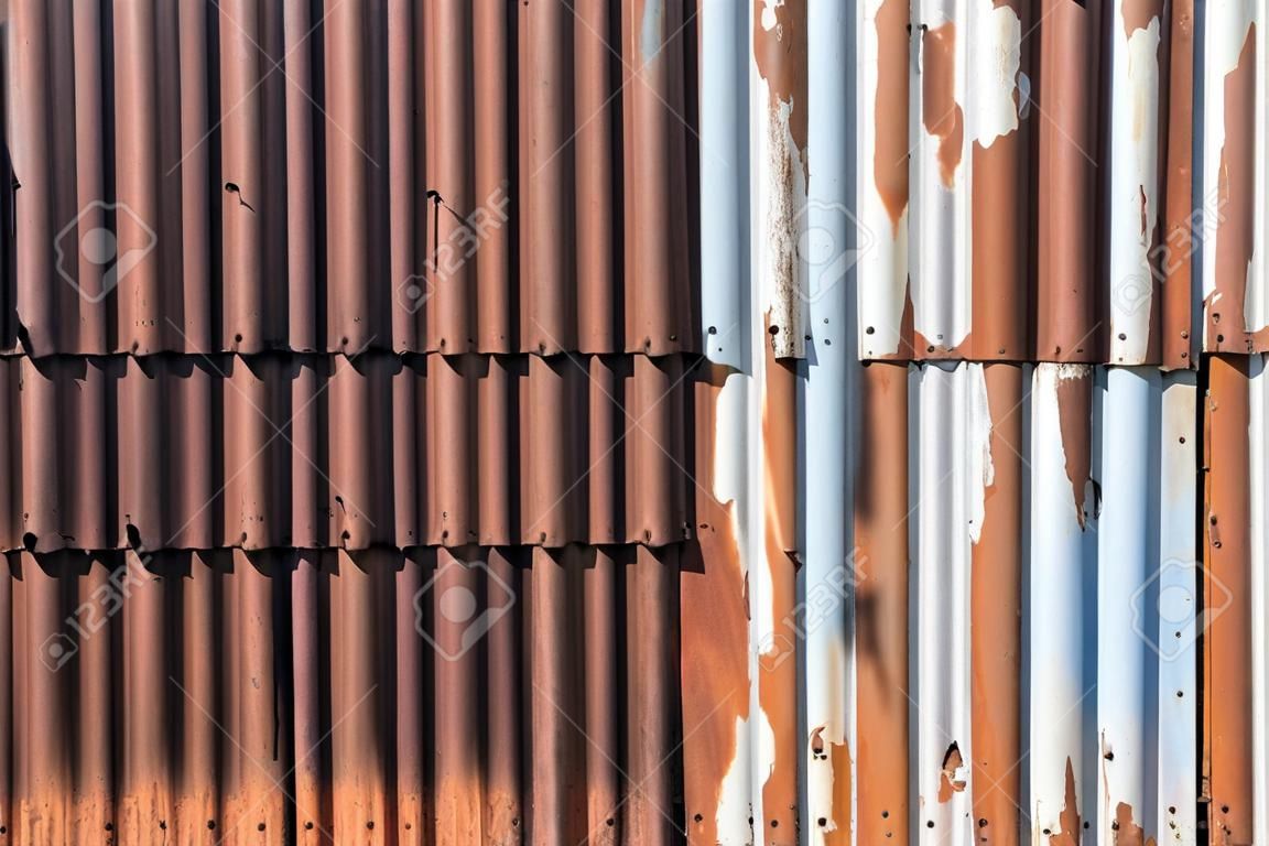 Old and rusty zinc sheet wall. Vintage style metal sheet roof texture. Pattern of old metal sheet. Rusting metal or siding. Corrosion of galvanized. Background and textures in retro concept.