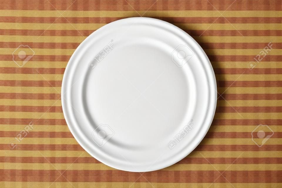 the empty plate on checkered tablecloth