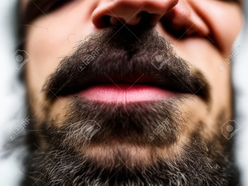 Close-up photo of lower part of the male face lips and beard