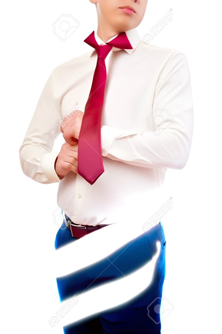 Young man is wearing a suit isolated on white. Businessman or student tie a tie. Groom prepearing for weeding.