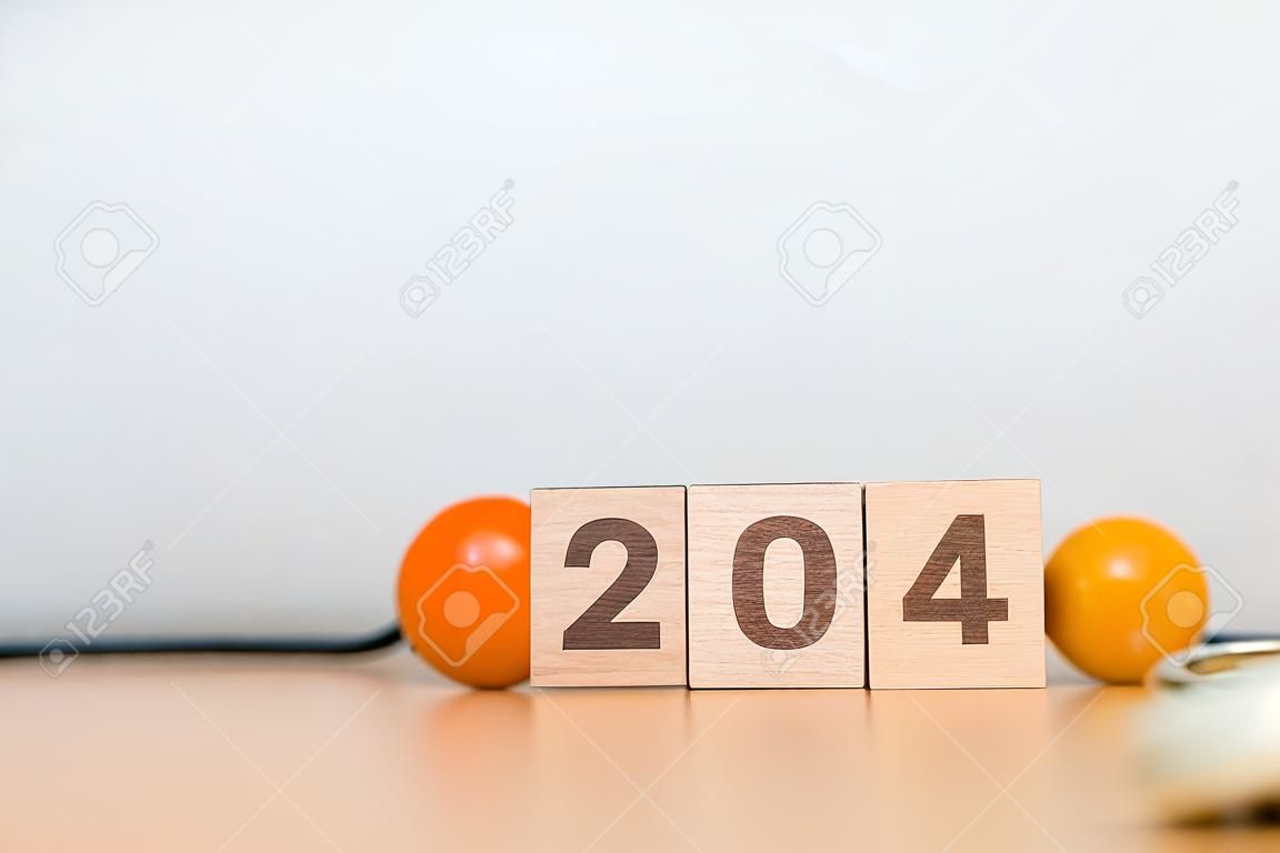 2024 Happy New Year for health care, Insurance, Wellness and medical concept. Stethoscope of doctor on table