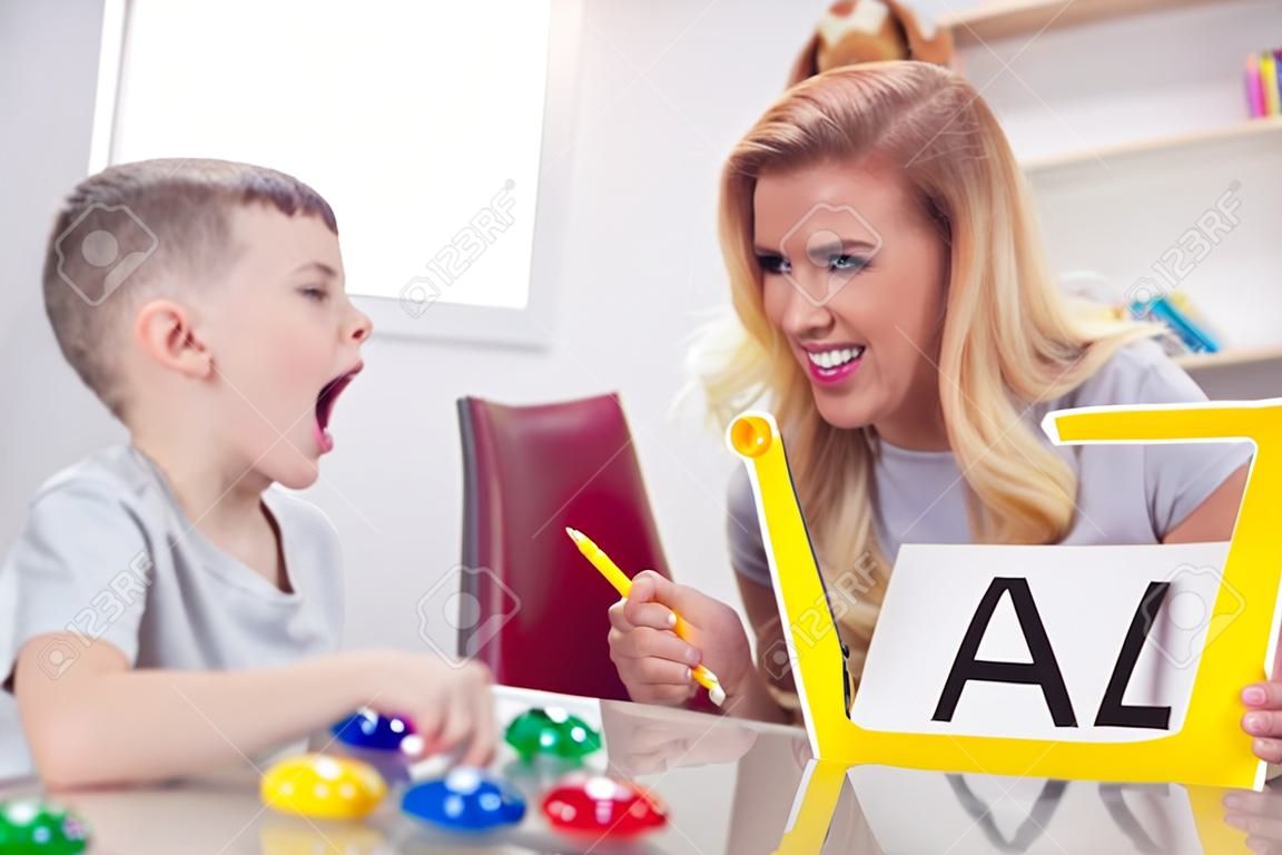 语言治疗师教孩子们说字母A。