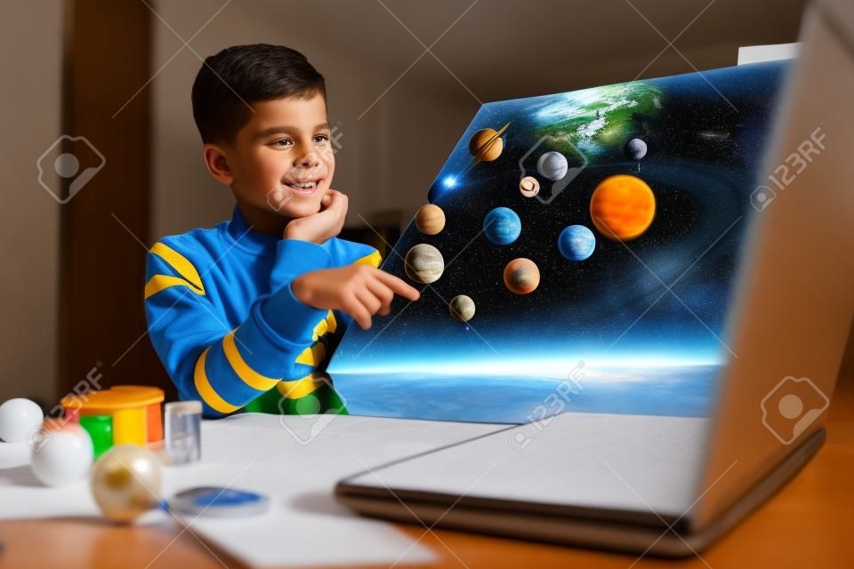 Kid presenting his science home project - the planets of our solar system. Distance learning online education.
