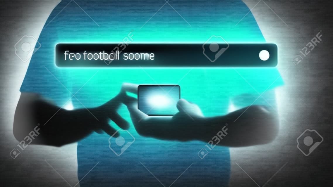 Football fan checking mobile phone gor live football scores in his home. Searching Browsing Internet Data Information with search bar. Search Engine technology networking Concept.