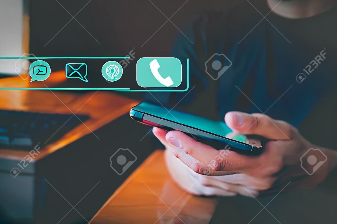 Contact us support hotline, people connect. User man use a smartphone with virtual screen member contact icons ( phone, live chat, email, address ). Customer service, helpdesk advice online support.