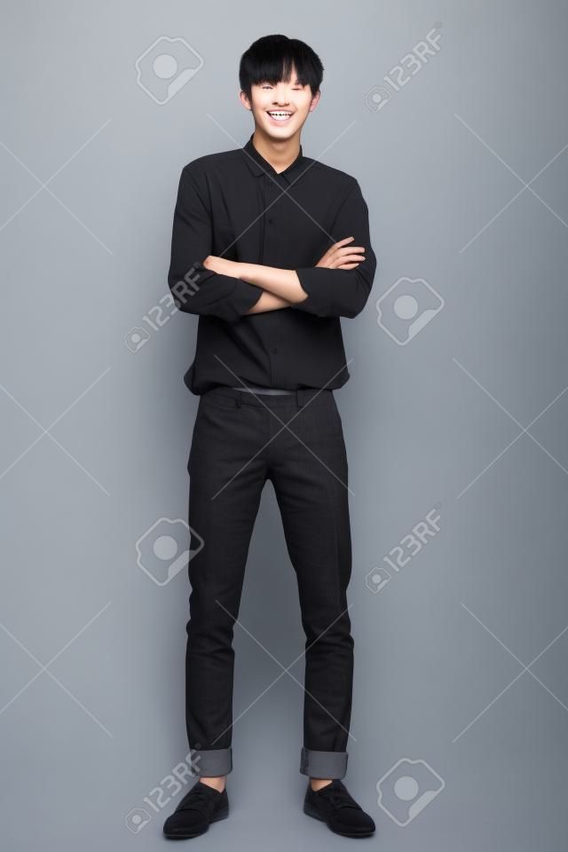 Studio full body portrait of a young asian man