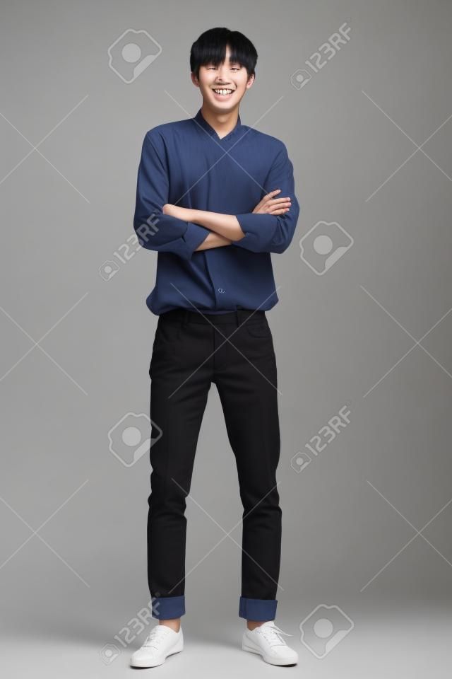 Studio full body portrait of a young asian man