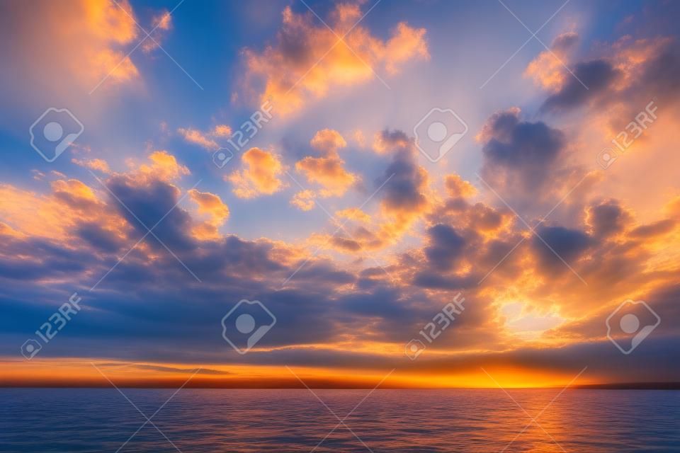 Tranquil lake scene at sunrise and clouds