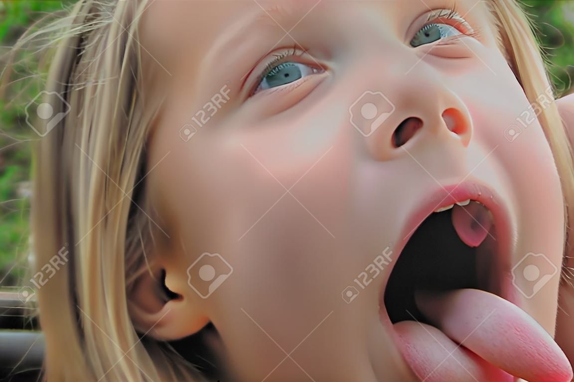 Portrait of girl with put out tongue