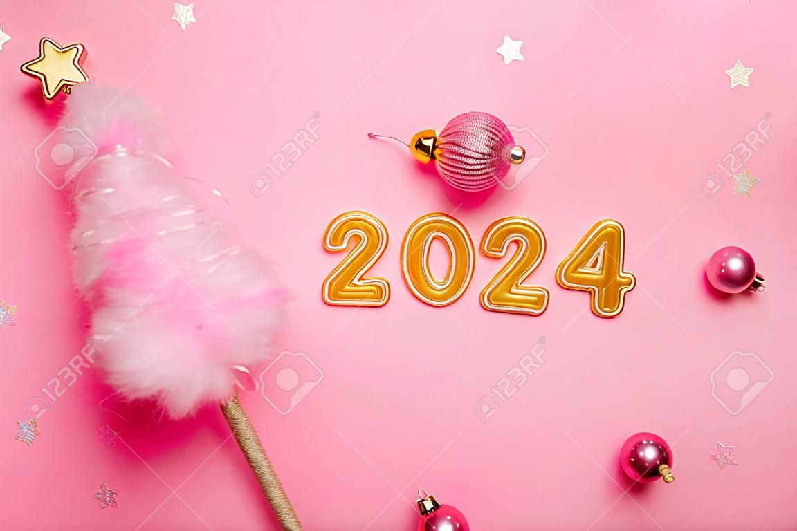 Draufsicht isoliert rosa Hintergrund flauschige Wolle kreativer Weihnachtsbaum goldene Zahlen 2024 mit Kugeln Neujahr Feiertagskartenvorlage Poster für Text Zuckerwatte Online-Verkäufe Einkaufen flach legen