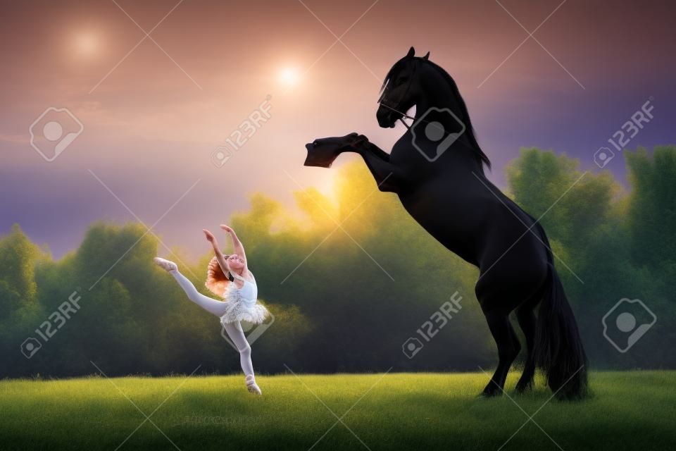 Little ballerina girl with black friesian stallion at summer evening