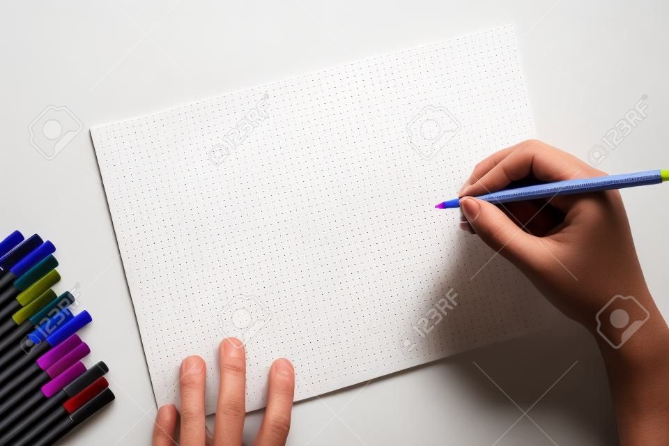 彩色筆和空白的紙，用手寫在空白頁上