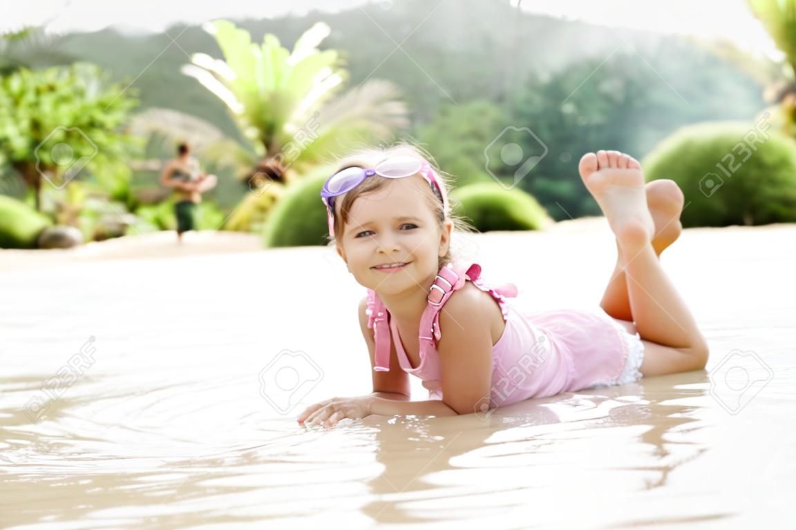 Adorable little girl have fun on the beach