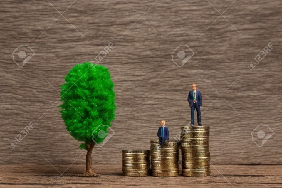 A miniature tree next to two miniature men with a pile of coins.