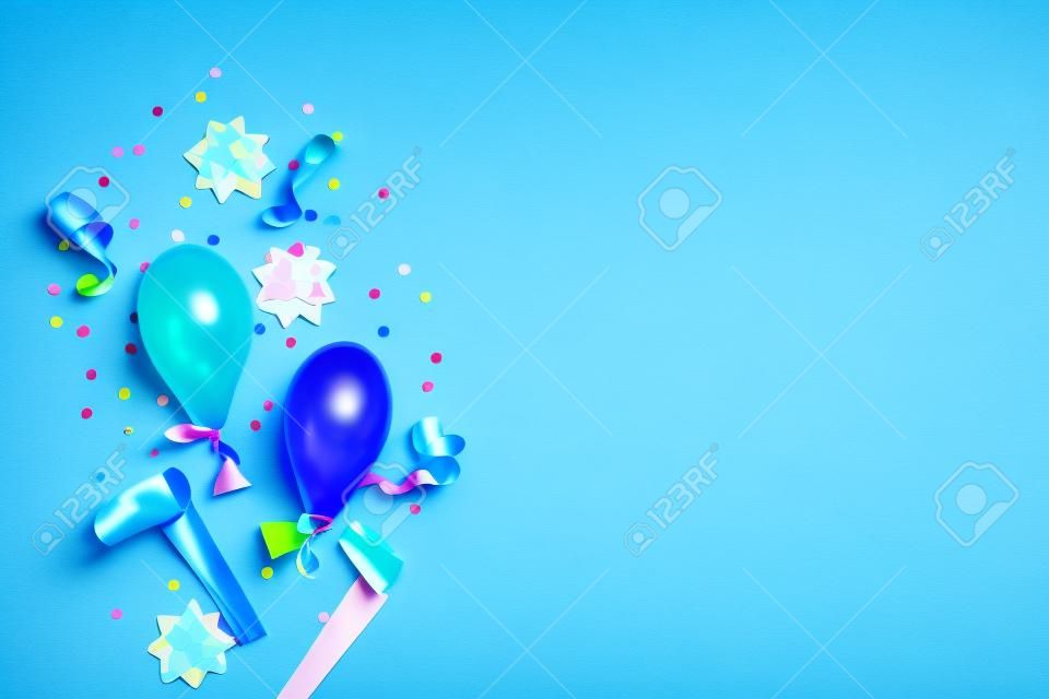 Gradient blue birthday background with colorful bows, baloons, streamers and confetti. Flat lay. Copy space