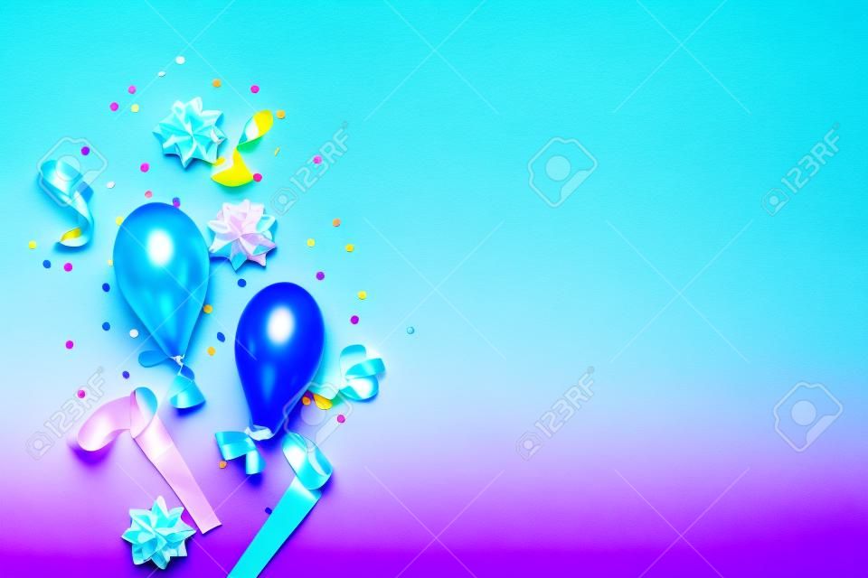Gradient blue birthday background with colorful bows, baloons, streamers and confetti. Flat lay. Copy space
