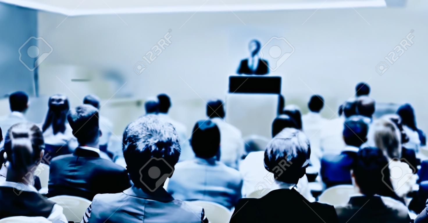Woman giving presentation on a business conference.