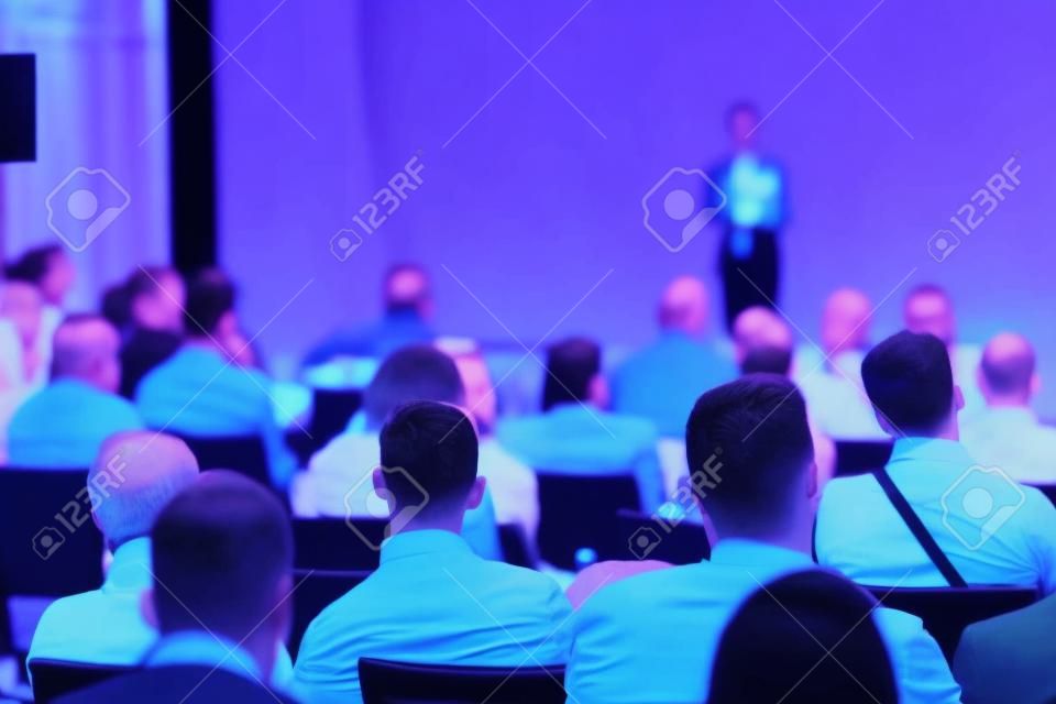Business speaker giving a talk at business conference event.