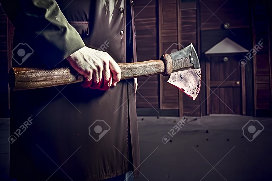 Axe with blood in male hand.  murderer or butcher, halloween theme