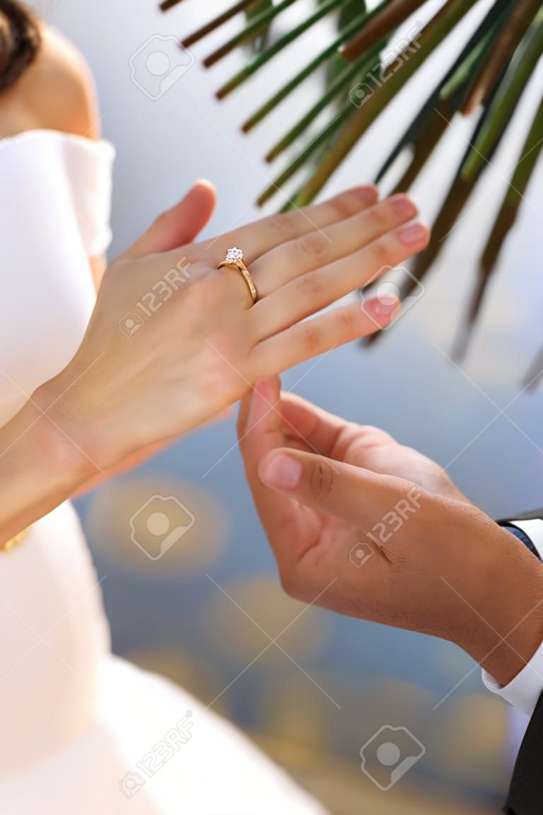 Close up view of hand during a marriage proposal
