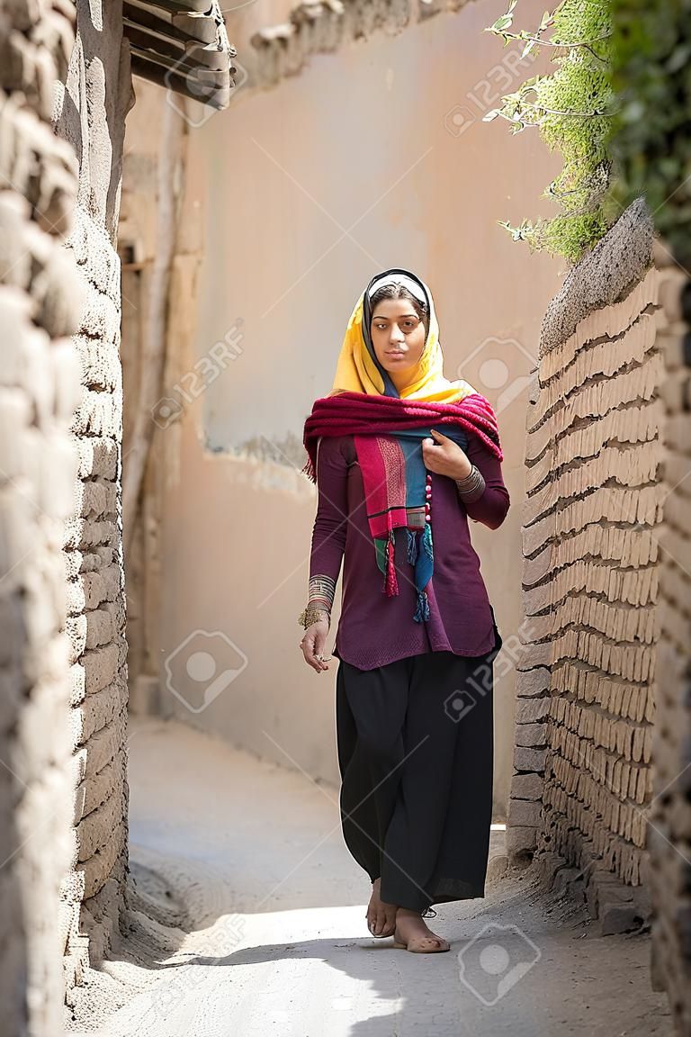 young beautiful iranian lady on the streets of an old village in Iran